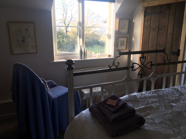 Peaceful bedroom at Tosturi Retreat House, Shropshire
