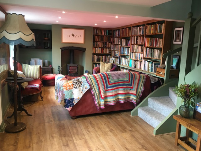 The lounge and our full bookshelves in the lounge at Tosturi Retreat House, Knowbury, Shropshire